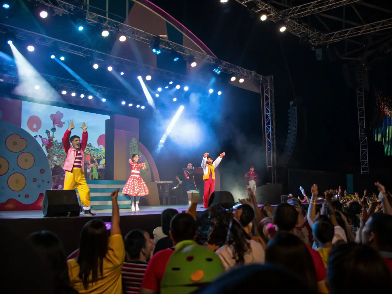 A photograph of an ALTESSES DU 16 event, showing a diverse group of people enjoying a performance and celebrating LGBTQ+ culture.