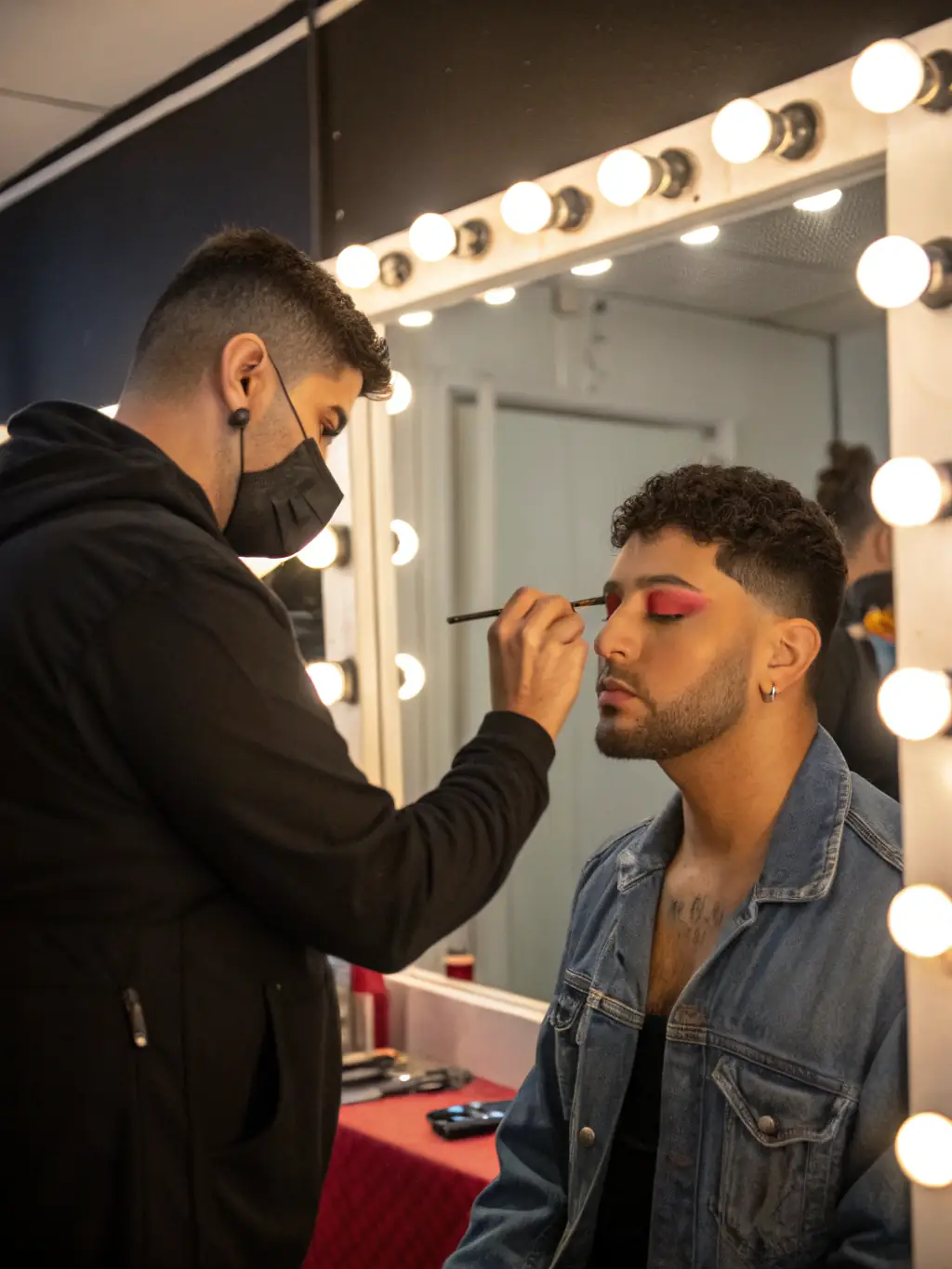 An image of a drag performer leading a makeup tutorial, demonstrating techniques for creating bold and expressive looks.